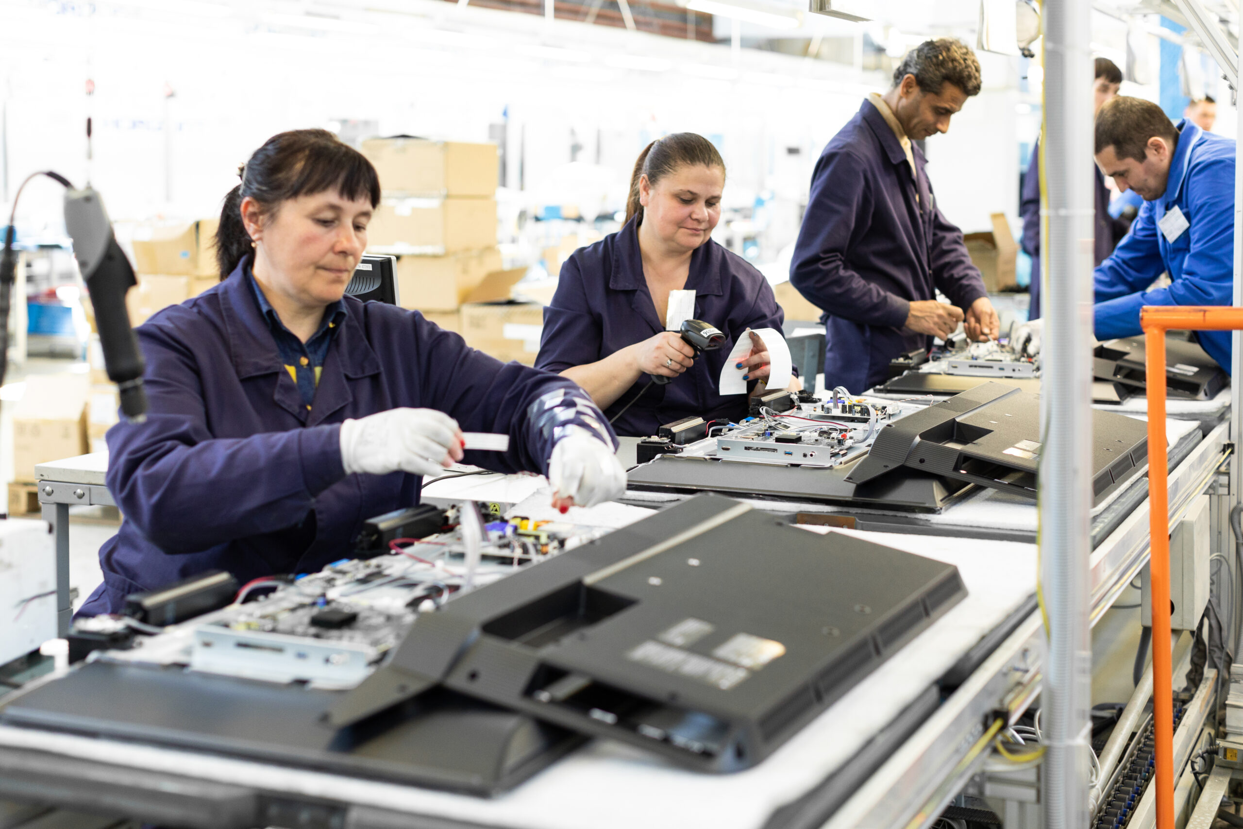 Workshop on assembling telephysics. Testing TVs in the workshop. Electronics assembly line.