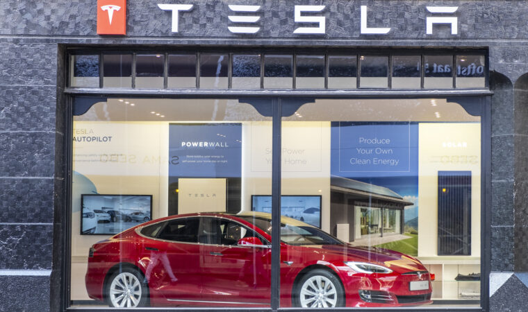 Tesla showroom in Amsterdam with a red Tesla Model S electric car on display inside